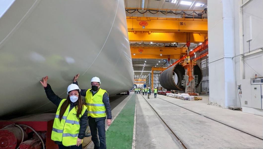 Commissioners Hasegawa and Felleman next to a wind turbine at a production facility in Bilbao, Spain.