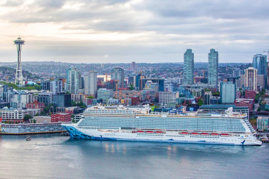 Norwegian Bliss cruise ship against the Seattle skyline