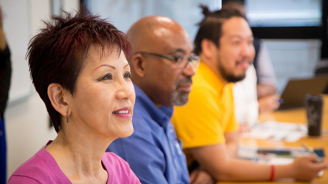 A diversity of employees learn together in a career development course.