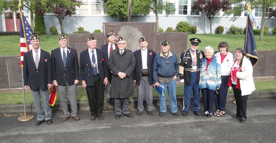American Legion Post 134 and Legion Auxiliary gathered on Memorial Day 2014 at the Memorial Wall in front of the old Sunnydale School, along the Living Road of Remembrance. Photo courtesy of the Des Moines Memorial Drive Preservation Association