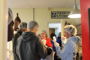 Students standing in a group with plastic hairnets on.