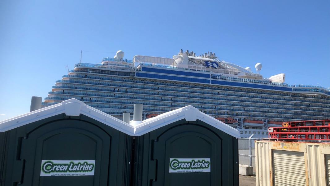 Cruise ship behind Green Latrine portable toilets.