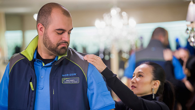 Luli Yang works in a uniform design with an Alaskan airline employee.