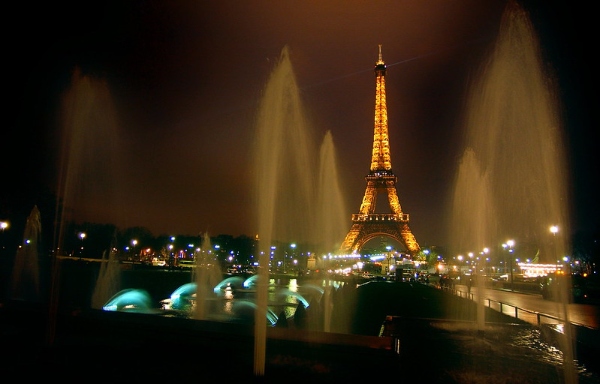 Streetscape of Paris with Eiffel tower and fountains at night