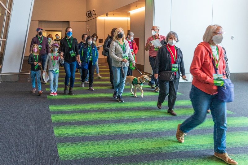 Passengers (and guide dog) walking in the IAF to help test