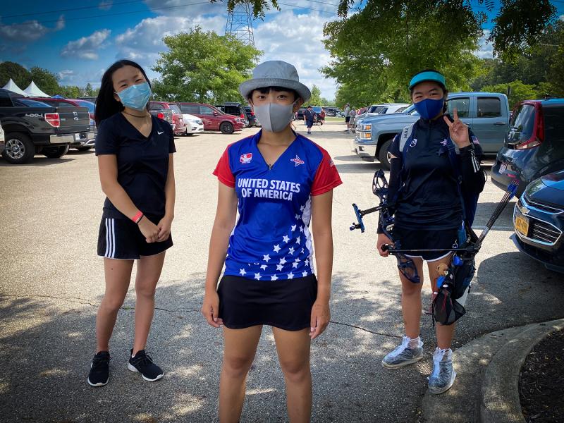 Gabi and friends wearing masks at a competition.