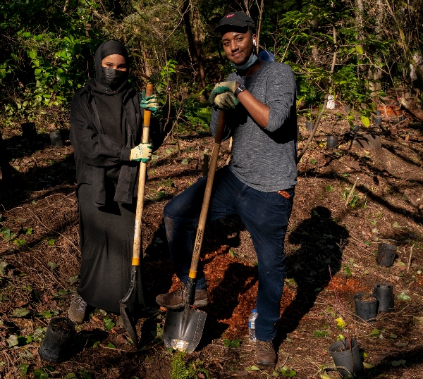 Two people planting trees at a Port event