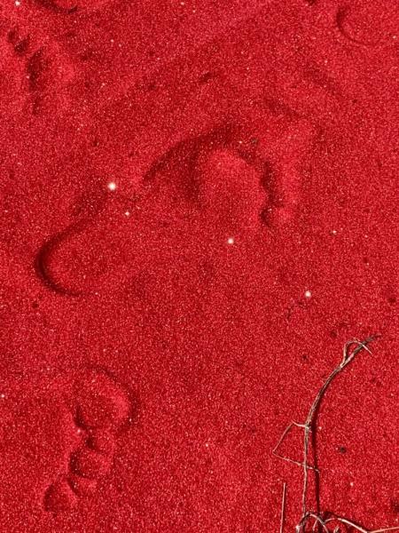 Red sand with footprints