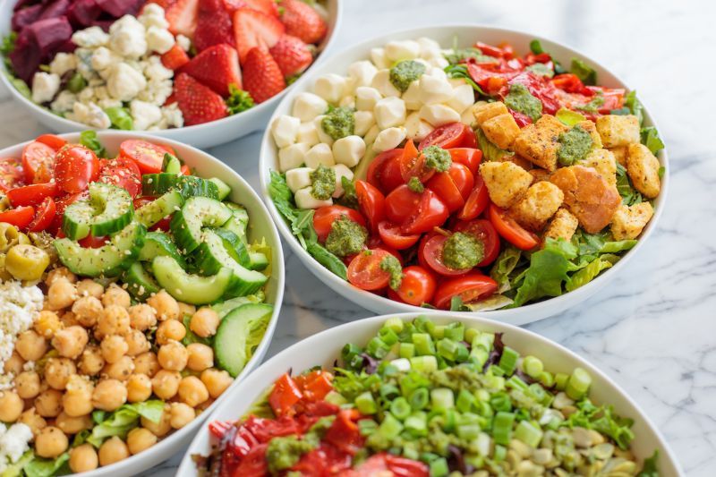 Four salads with colorful and healthy ingredients