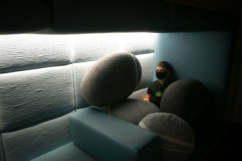 Boy in the nook at the sensory room having quiet time