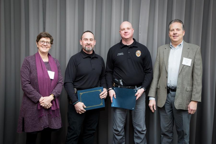 Officer Russo and Sgt Urbauer stand with Maritime Managing Director Stephanie Jones Stebbins and Chief Financial Officer Dan Thomas.