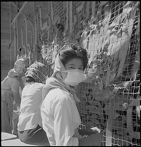 Japanese women working at the camps wearing a mask