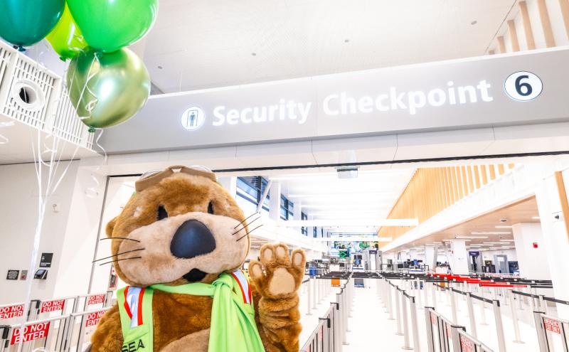 Jett the SEA Otter celebrates the opening of Checkpoint 6 with balloons