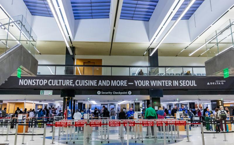 Travelers waiting in line at Checkpoint 4 at SEA Airport