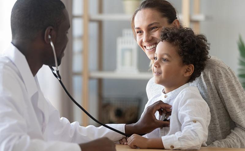 Doctor listening to child's heart