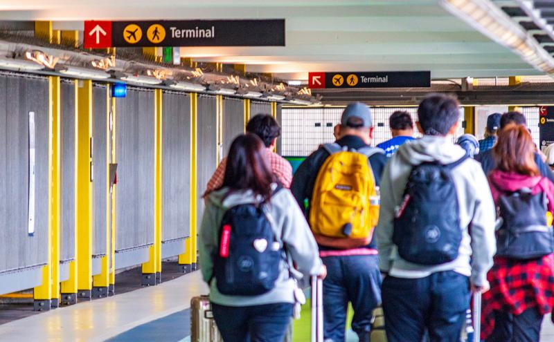 Passengers walk from SEA to the Link light rail station