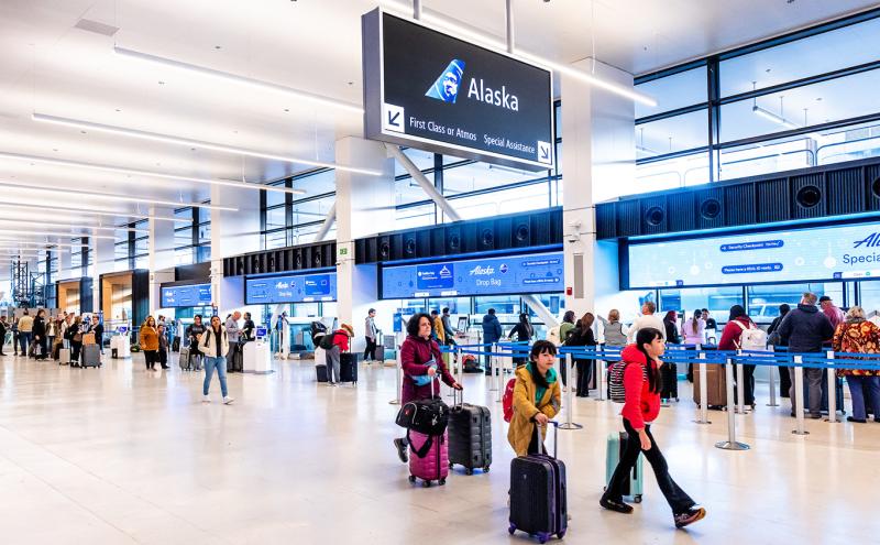 Travelers walk through SEA's check-in space at part of SEA Gateway.