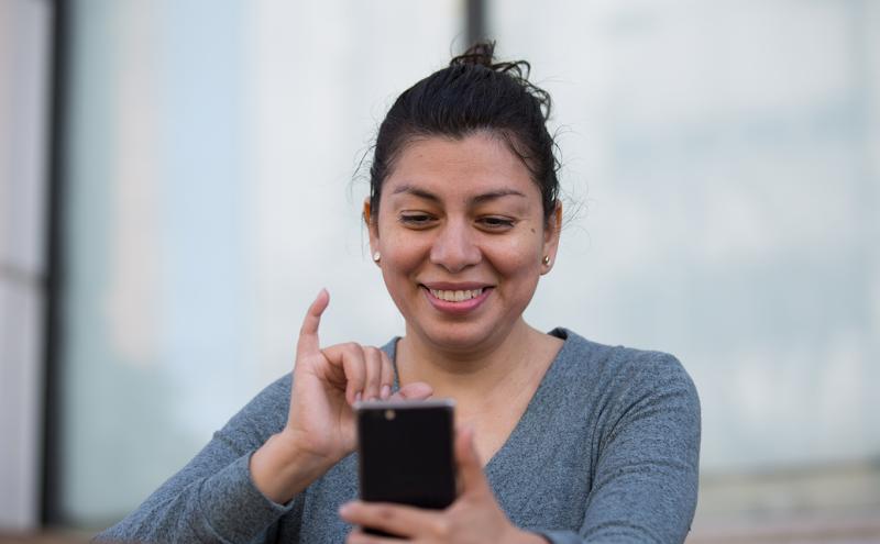 Woman using Mobile VRI technology on her phone.
