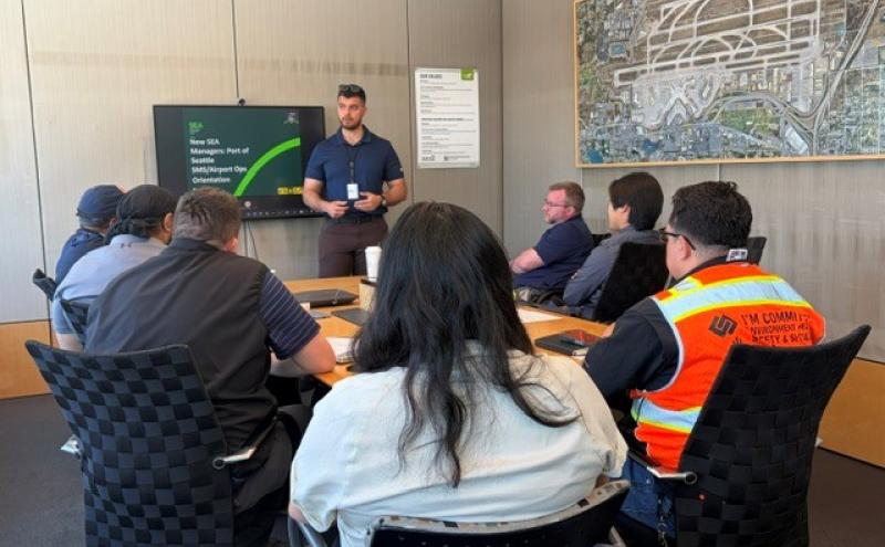 Airport Operations Orientation with Stakeholder Managers presentation in conference room.