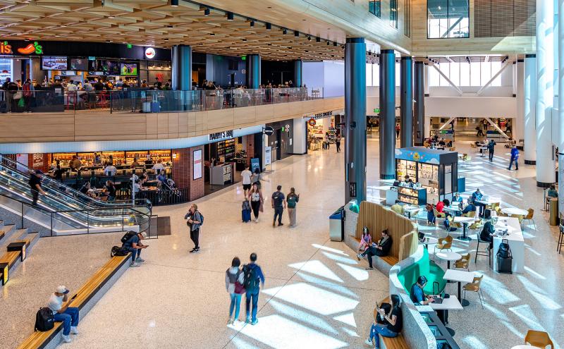 View inside the C Concourse Expansion showing Chili's, Nanny's, and retail kiosks.
