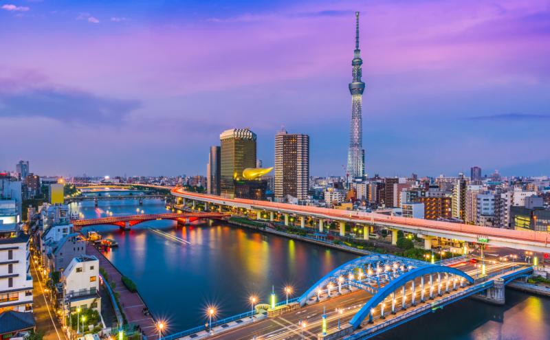 The colors of sunset off Tokyo's Sumida River highlight the art deco blue arches of Komagata Bridge, 2,080-foot-tall Tokyo Skytree building, and the golden Asahi Building.