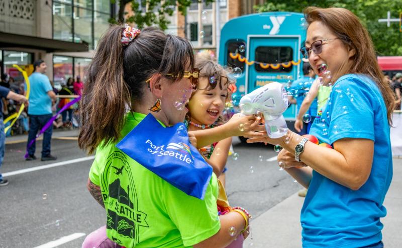 Commissioner Toshiko Grace Hasegawa, her daughter Keiko, and Commission Strategic Advisor Erica Chung at the Seattle Pride Parade
