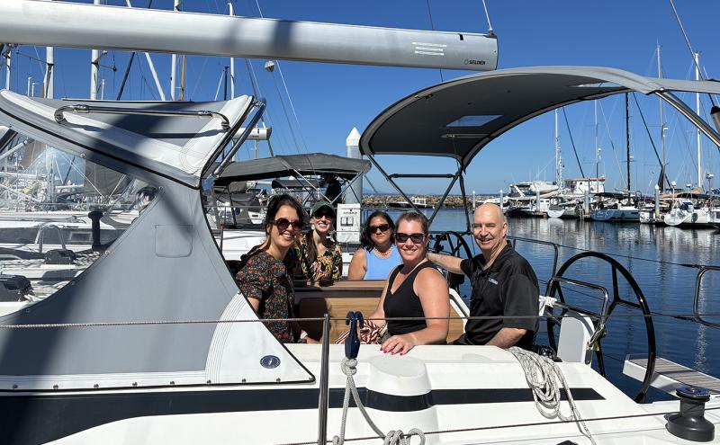 Captain and four passengers pose for a photo before a chartered sail boat cruise with Windworks Sailing and Powerboating