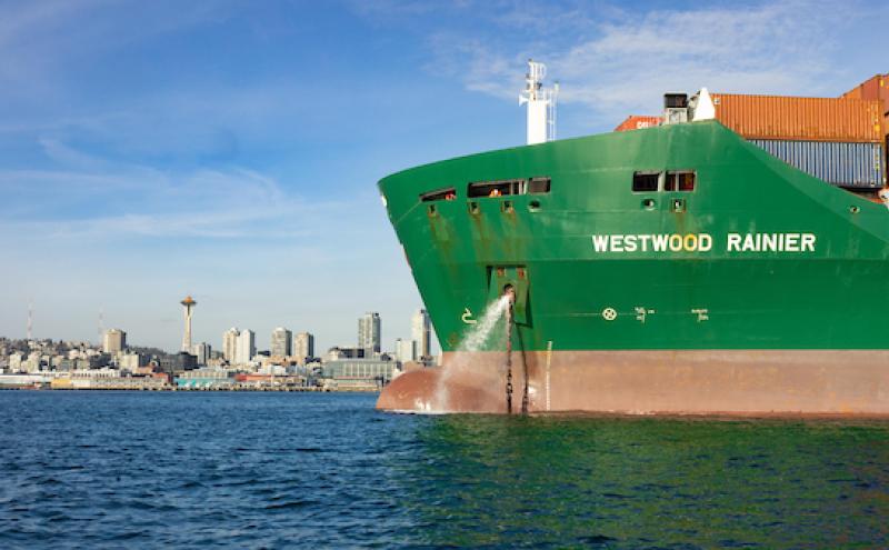 Cargo ship in front of the Seattle skyline
