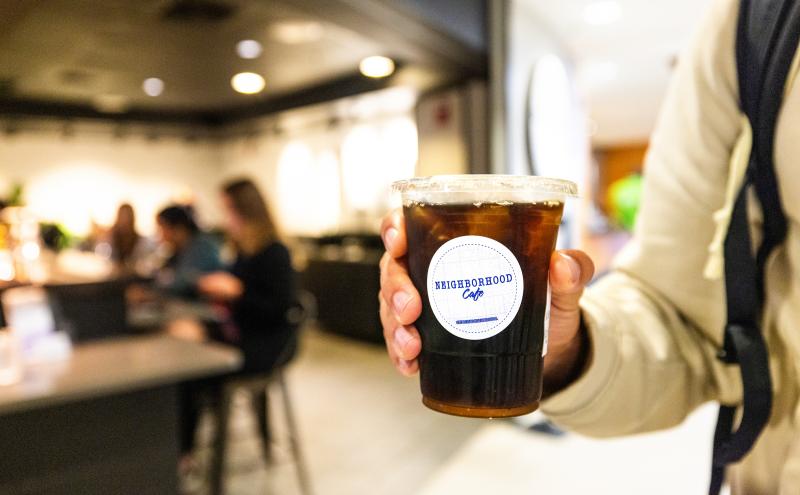 Customer holding an iced coffee