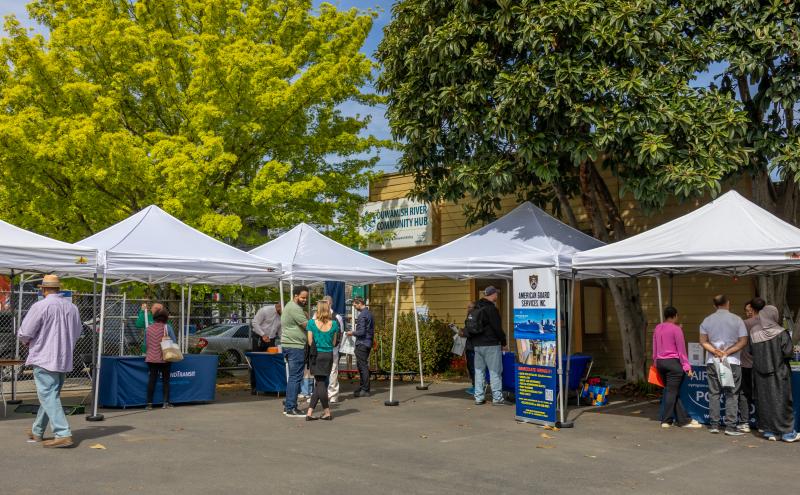 Tabling event with canopies in the Duwamish River Community Hub 