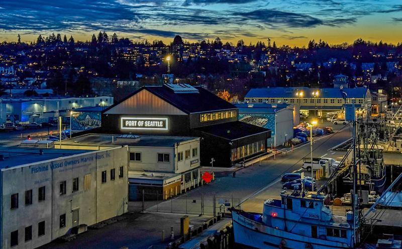 Fishermen's Terminal building shots at night time with Port of Seattle sign lit up on Maritime Innovation Center building