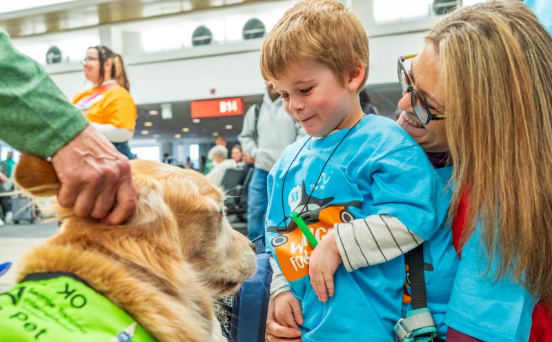 A boy and his mother meet one of the SEA Pups at the Wings for All event on Saturday, October 17