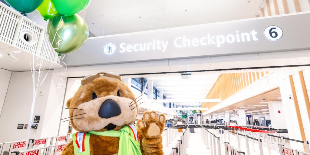 Jett the SEA Otter celebrates the opening of Checkpoint 6 with balloons