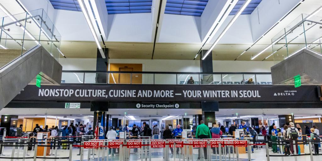 Travelers waiting in line at Checkpoint 4 at SEA Airport