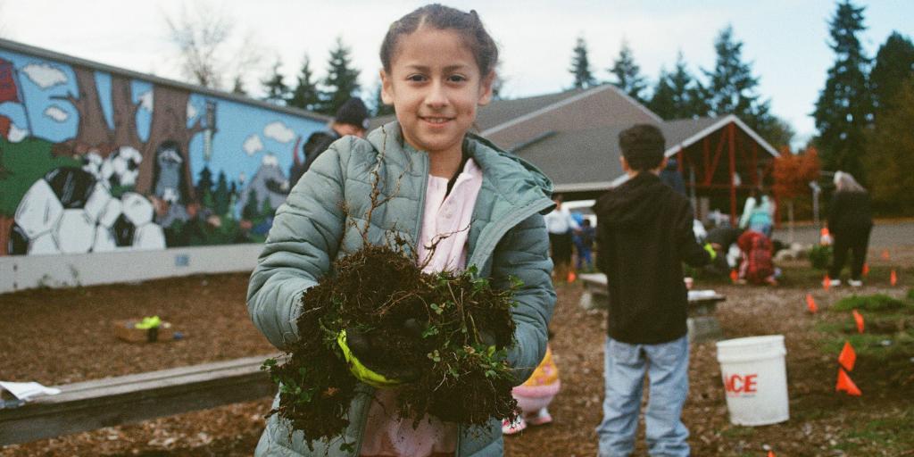 Seahurst Elementary student works in a rain garden at the school