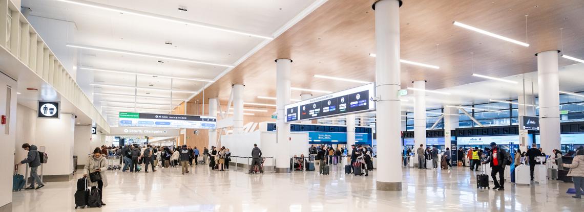 Travelers moving through the newly remodeled north end of SEA Airport's main terminal.