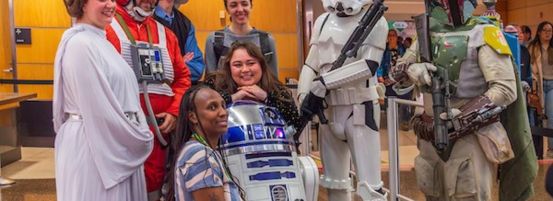 Cosplayers dressed as Star Wars characters pose with travelers in the terminal