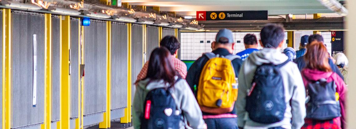 Travelers walking to SEA's Link light rail station
