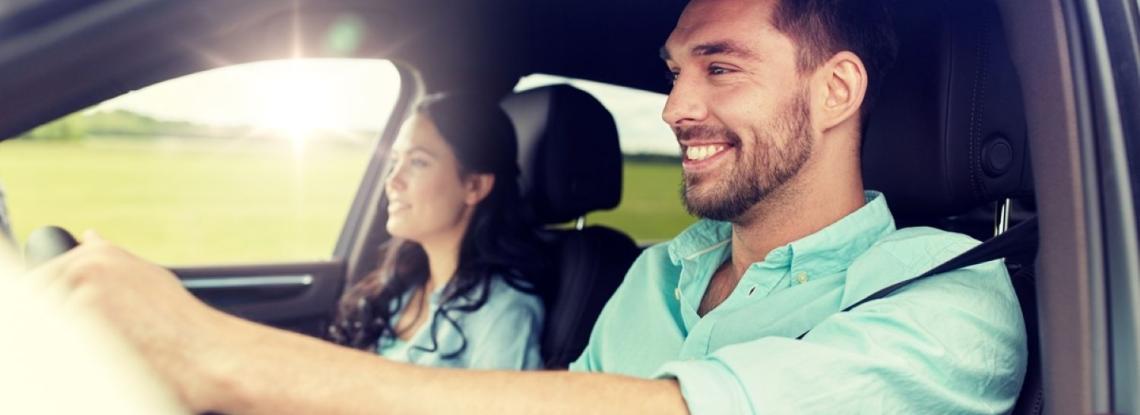 Young couple driving in a car.