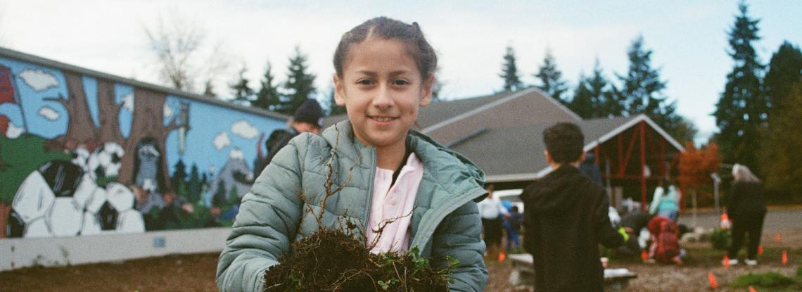 An Seahurst Elementary student works in a rain garden at the school