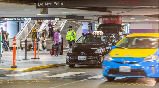 Taxis Picking Up Passengers on the Curb