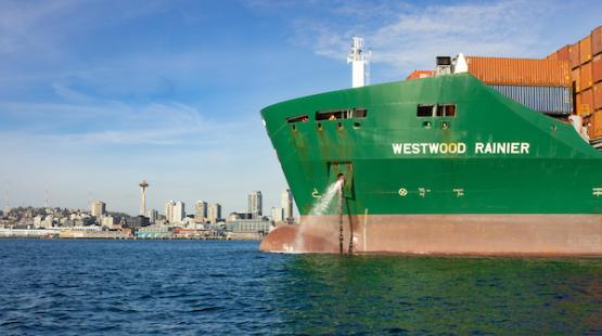 Cargo ship in front of the Seattle skyline