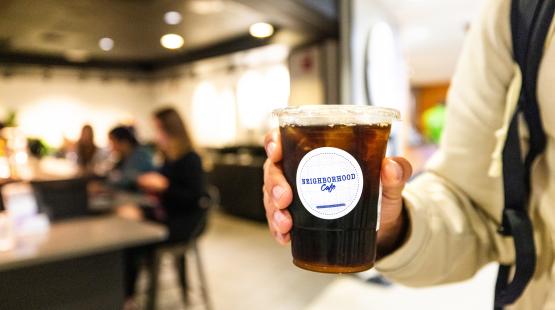 Customer holding an iced coffee