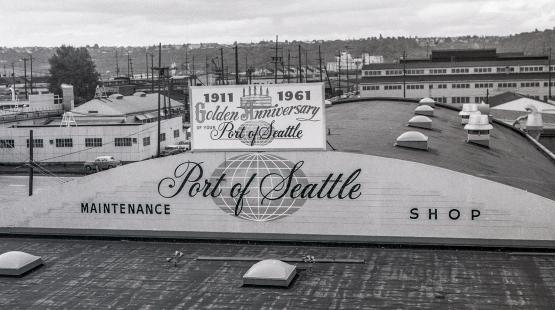Historic photo of the Port of Seattle’s Marine Maintenance building with signage indicating the Port’s anniversary in 1961.