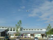Image of school with airplane flying overhead