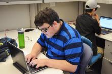 Photo of ICT Intern, Oliver Lindseth working at a computer