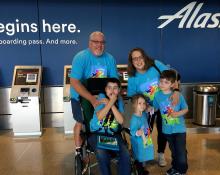 A family of passengers wearing T-shirts for a Wings for Autism event