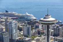 Aerial image of Space Needle and cruise ship in background