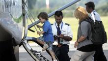 Passengers board a small commuter plane
