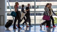 Passengers crossing a skybridge at Sea-Tac Airport
